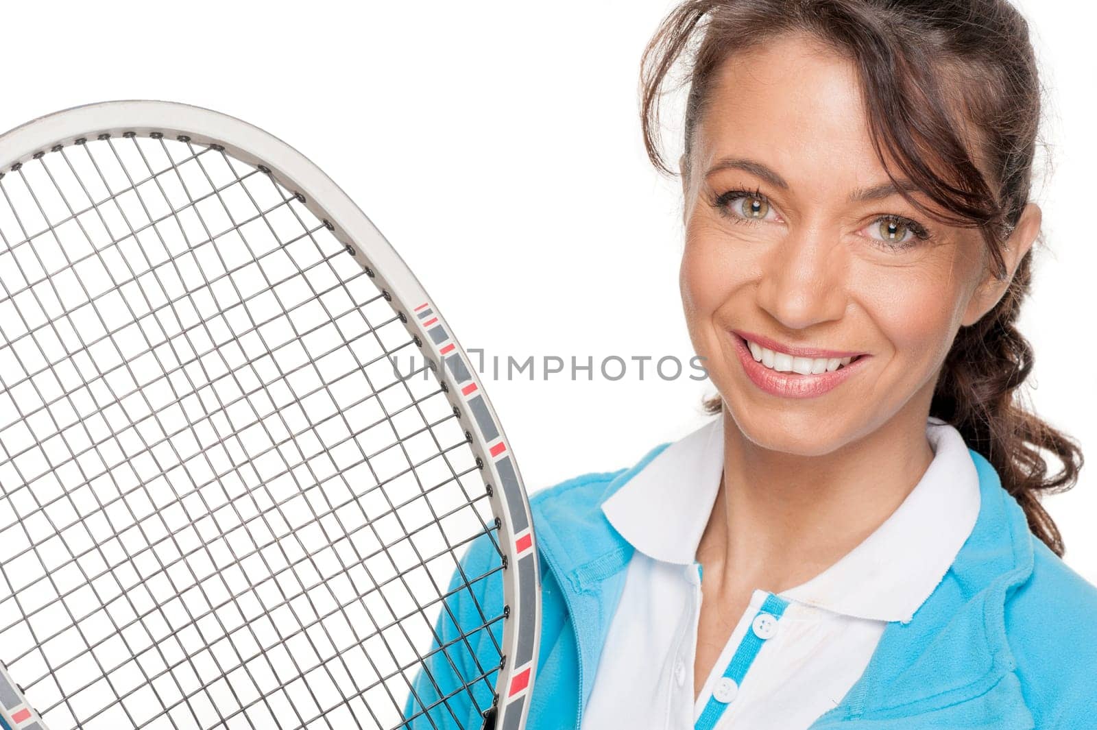Sporty woman with a tennis racket in front of a white background