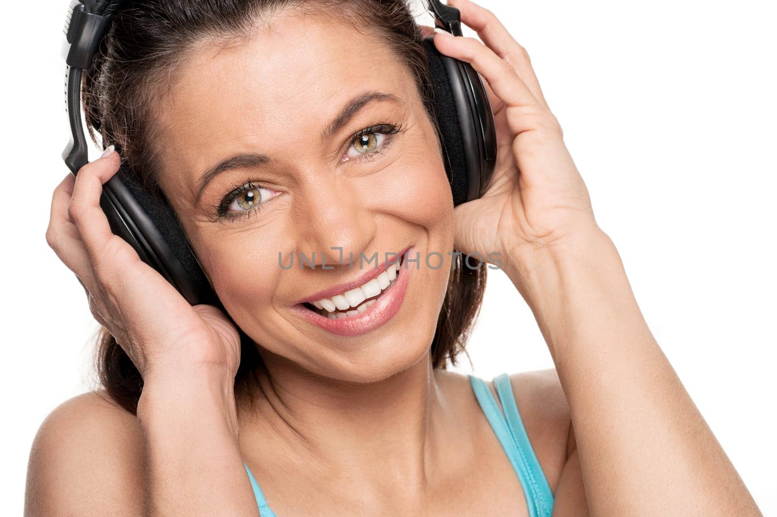 Smiling woman with a headphone against a white background