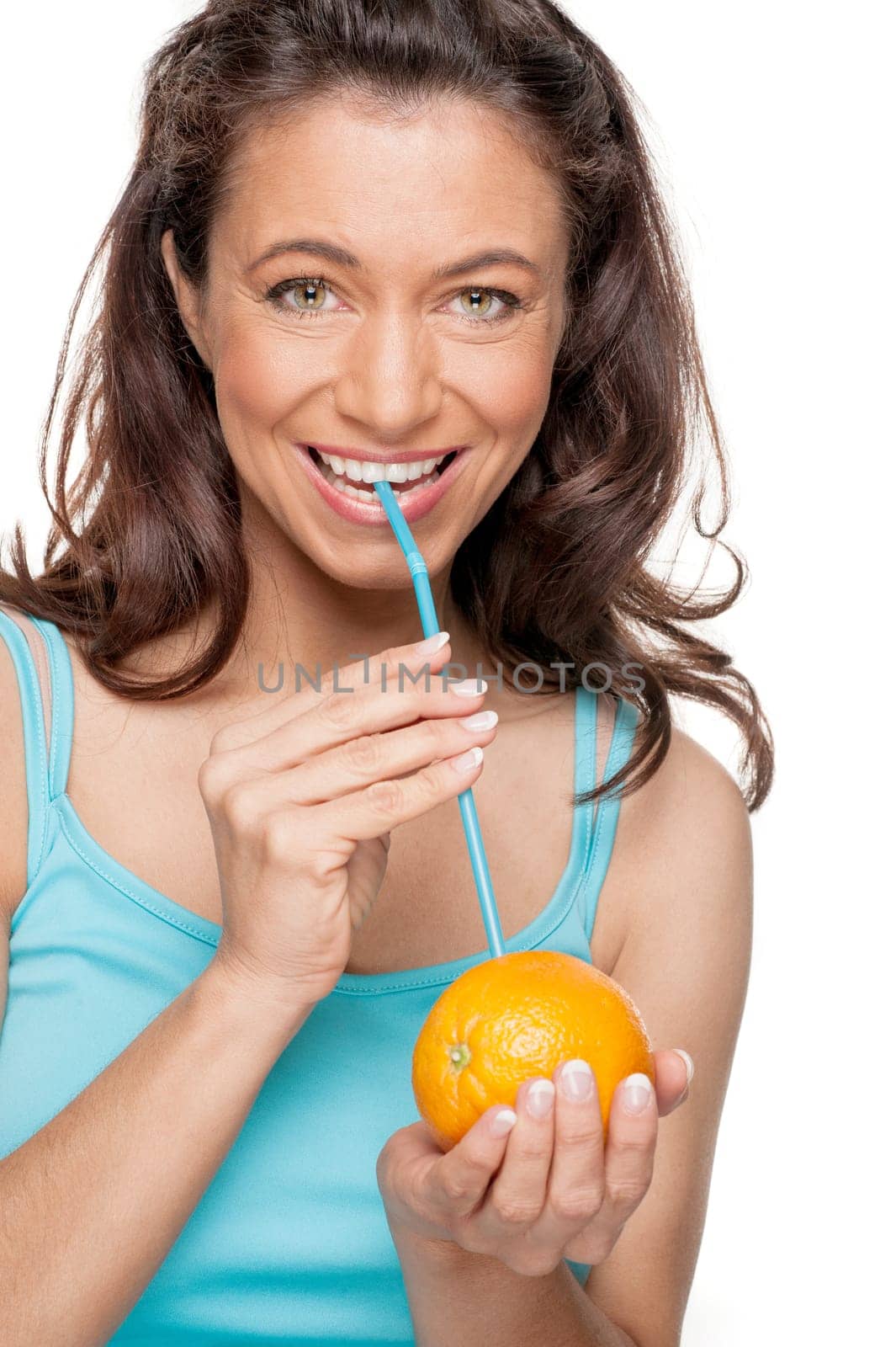 Smiling woman with a straw and an orange