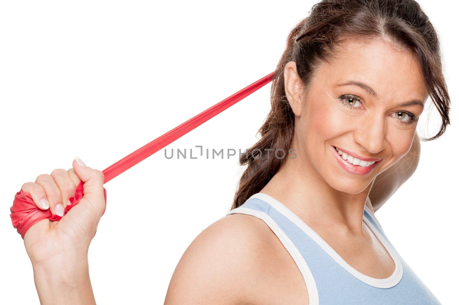 Sporty woman with a red gymnastics ribbon in front of a white background