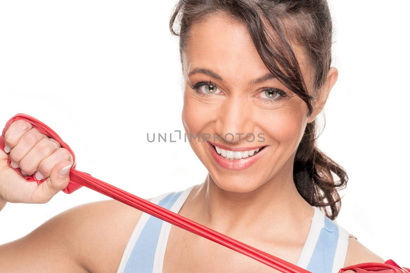Sporty woman with a red gymnastics ribbon in front of a white background