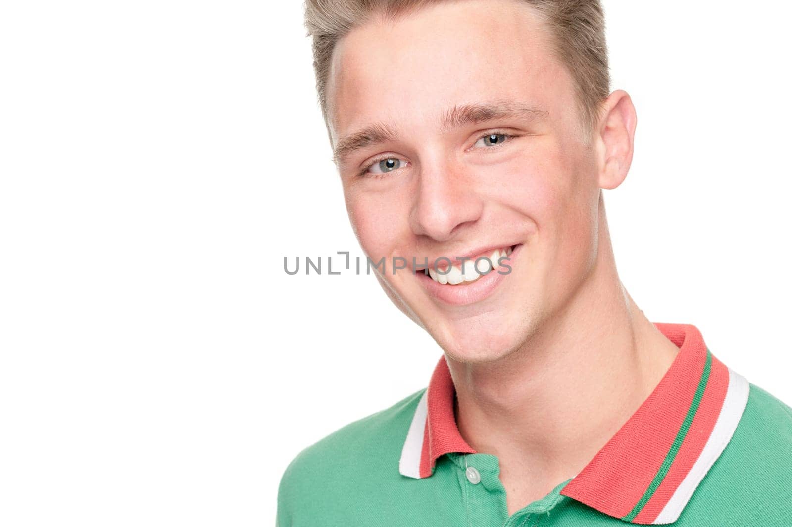 Smiling young man in front of white background