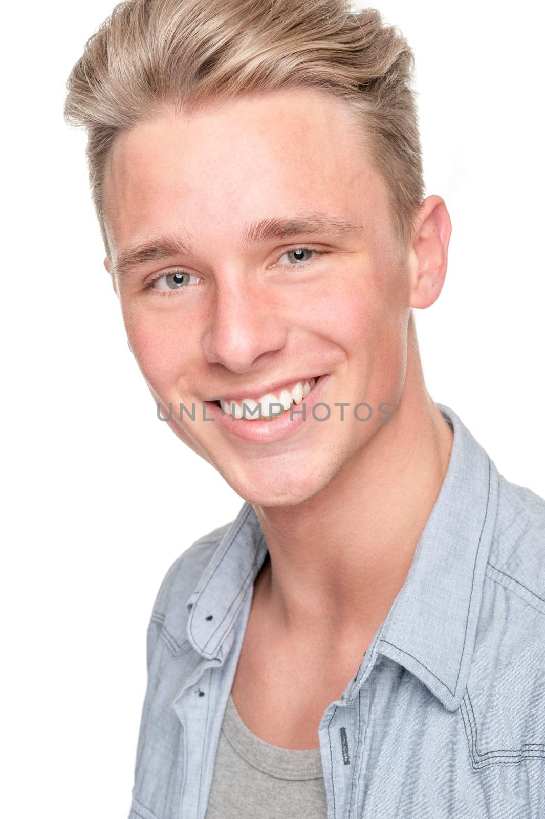 Smiling young man in front of white background