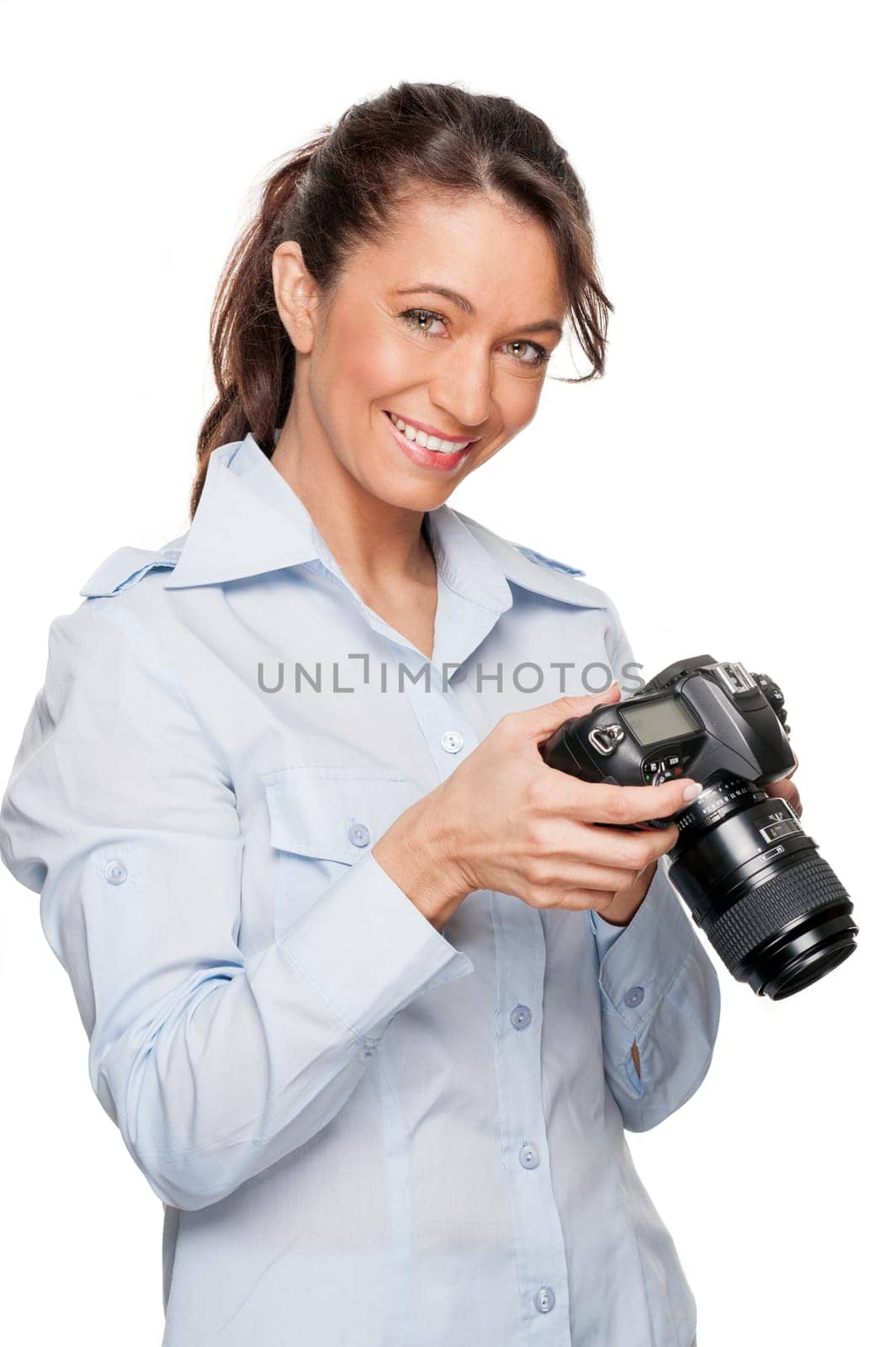 Smiling woman with a camera against a white background
