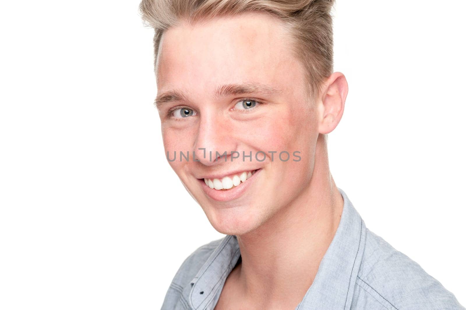 Smiling young man in front of white background