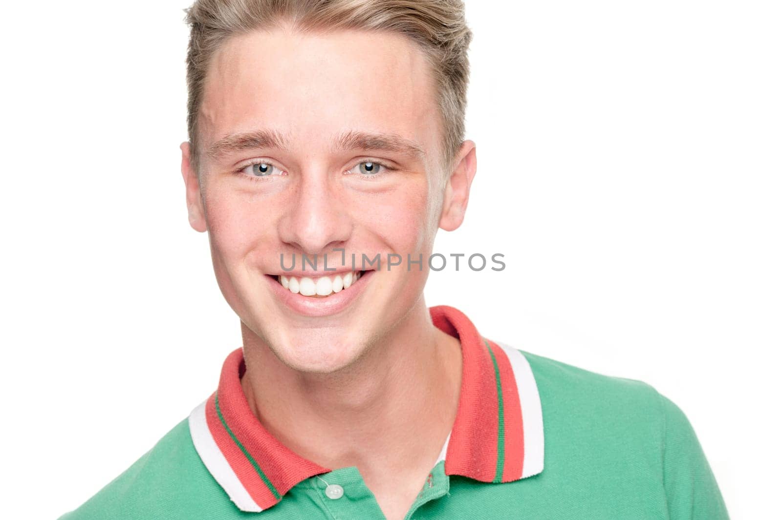 Smiling young man in front of white background