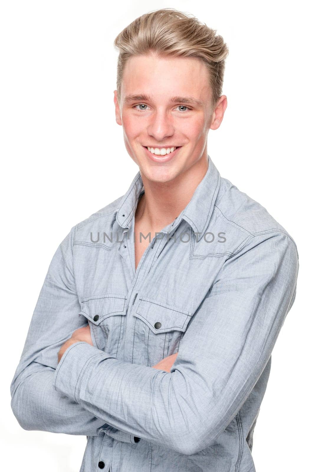 Smiling young man in front of white background