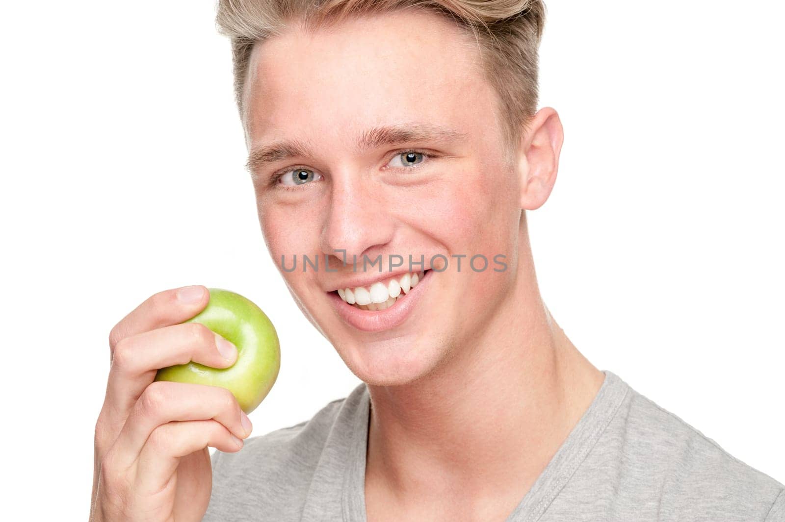 Young and smiling man with an apple