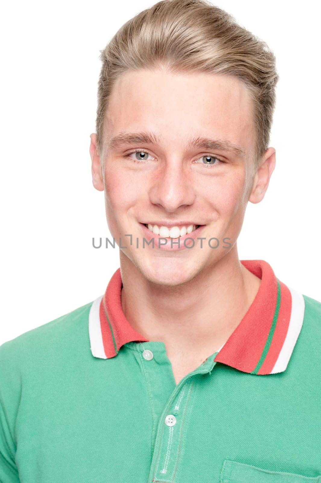 Smiling young man in front of white background