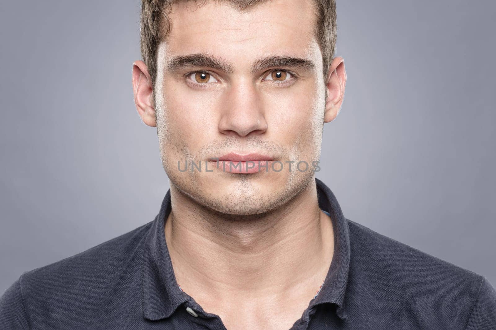Portrait of a young man against a blue background