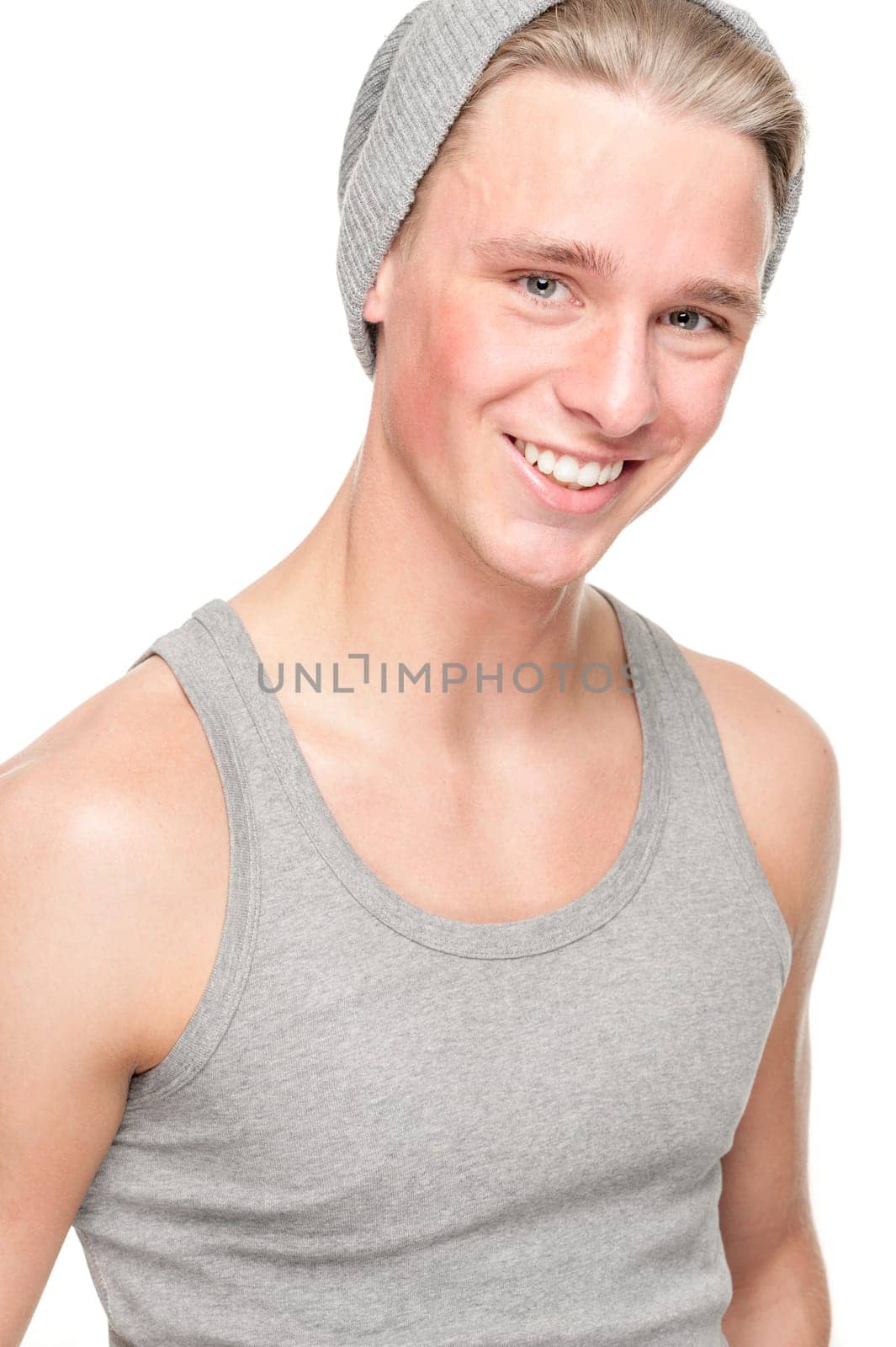 Smiling young man in front of white background