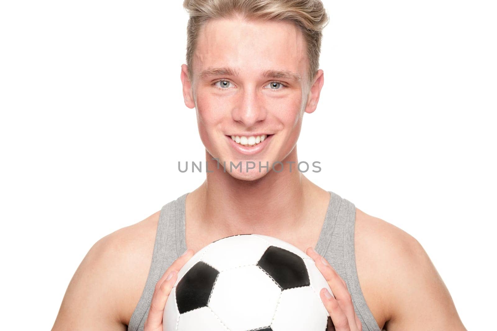 Young man with a soccer ball against a white background