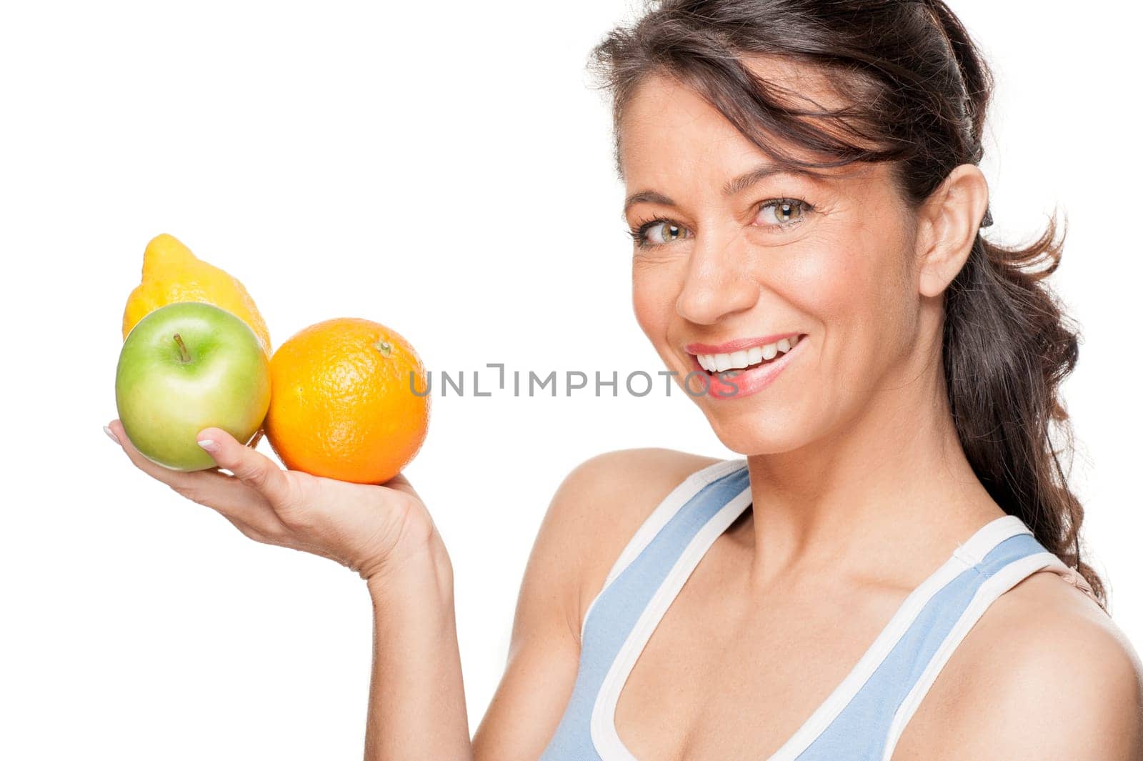 Smiling woman in front of white background with fruit