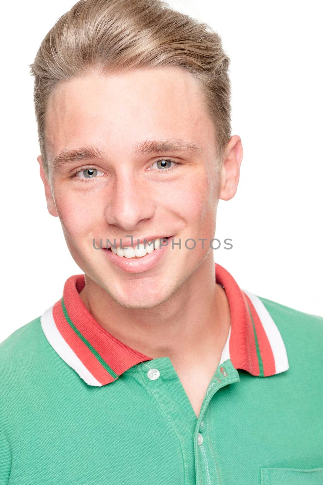 Smiling young man in front of white background