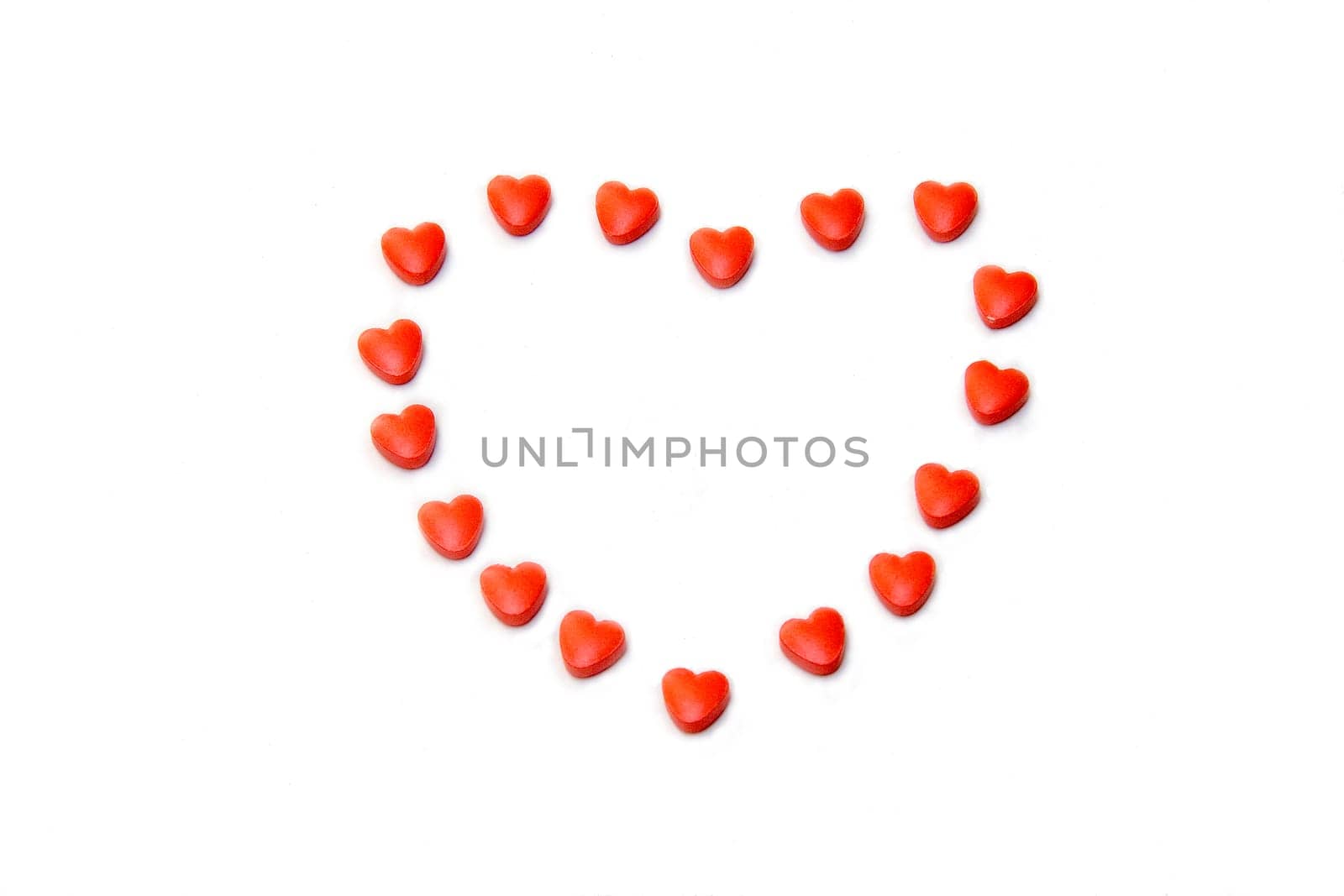 Arrangement of heart care tablets in heart shape, isolated on white