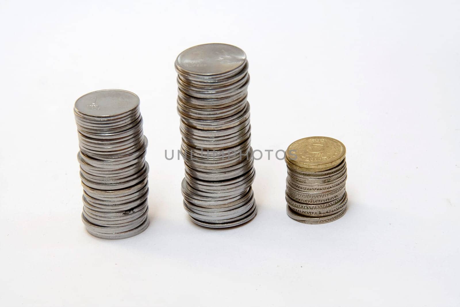 Columns of coins indicating trends in financial market, isolated on white