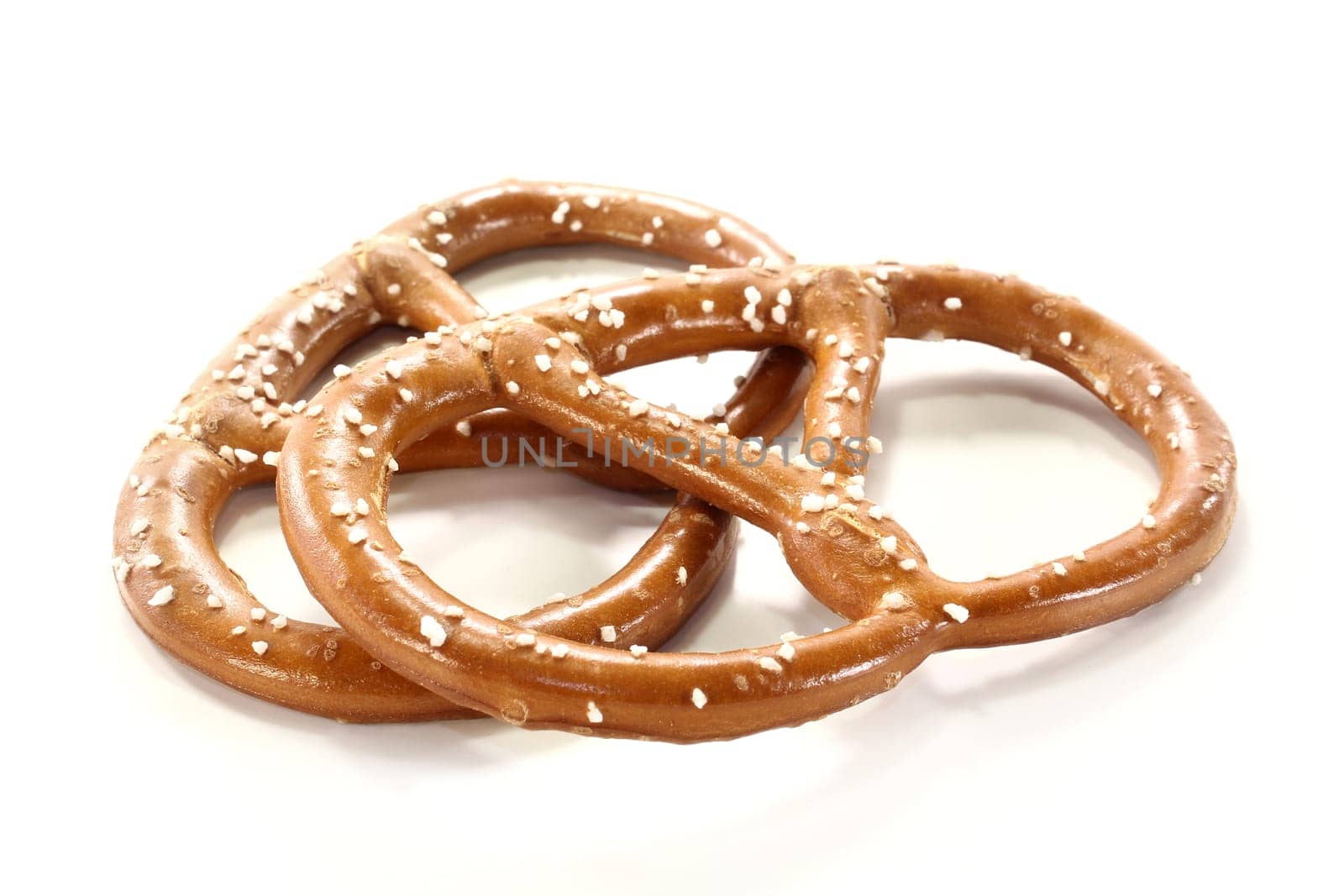 Two pretzels against white background