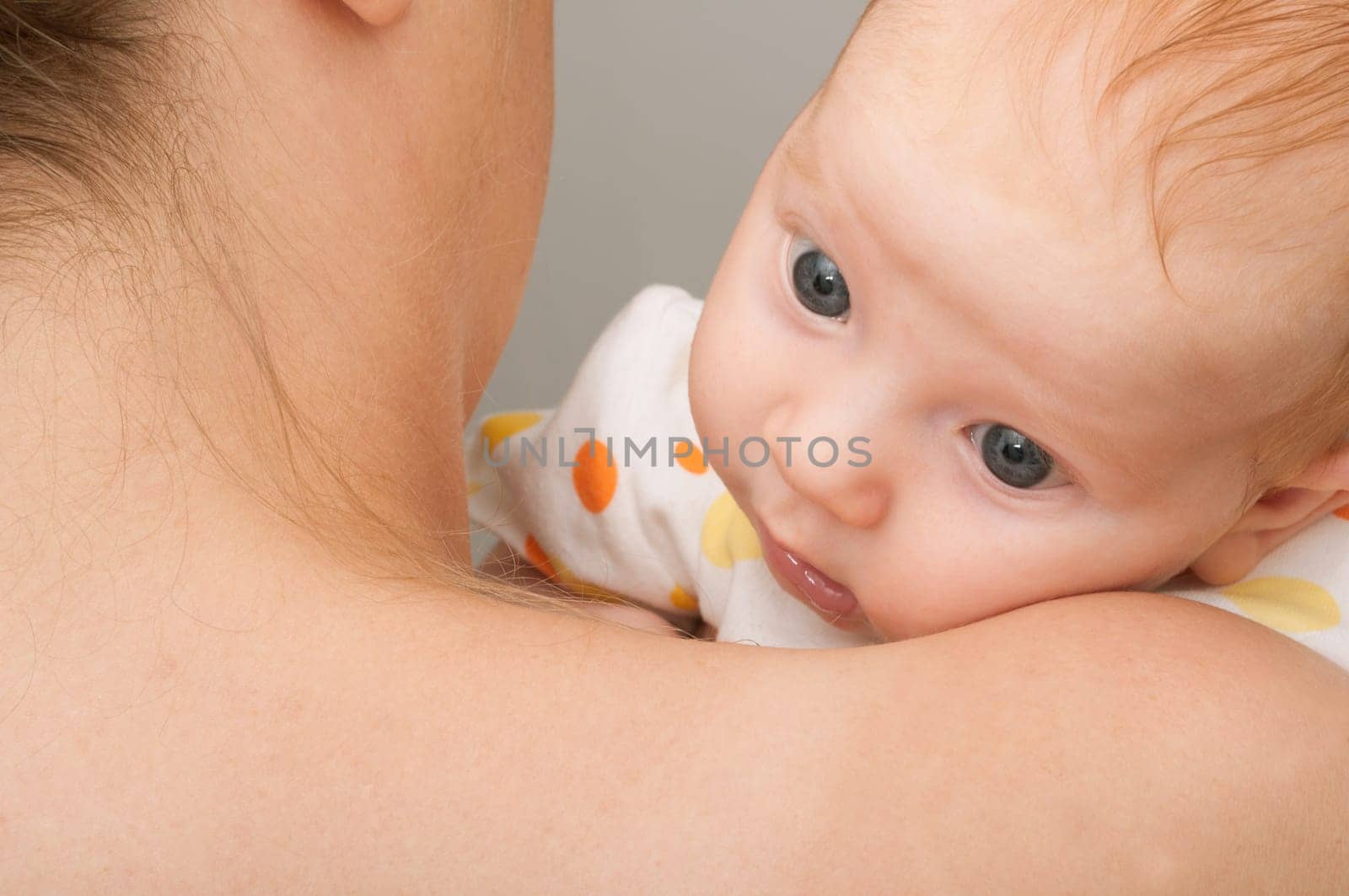 Mother from Behind Holding Cute Newborn Baby