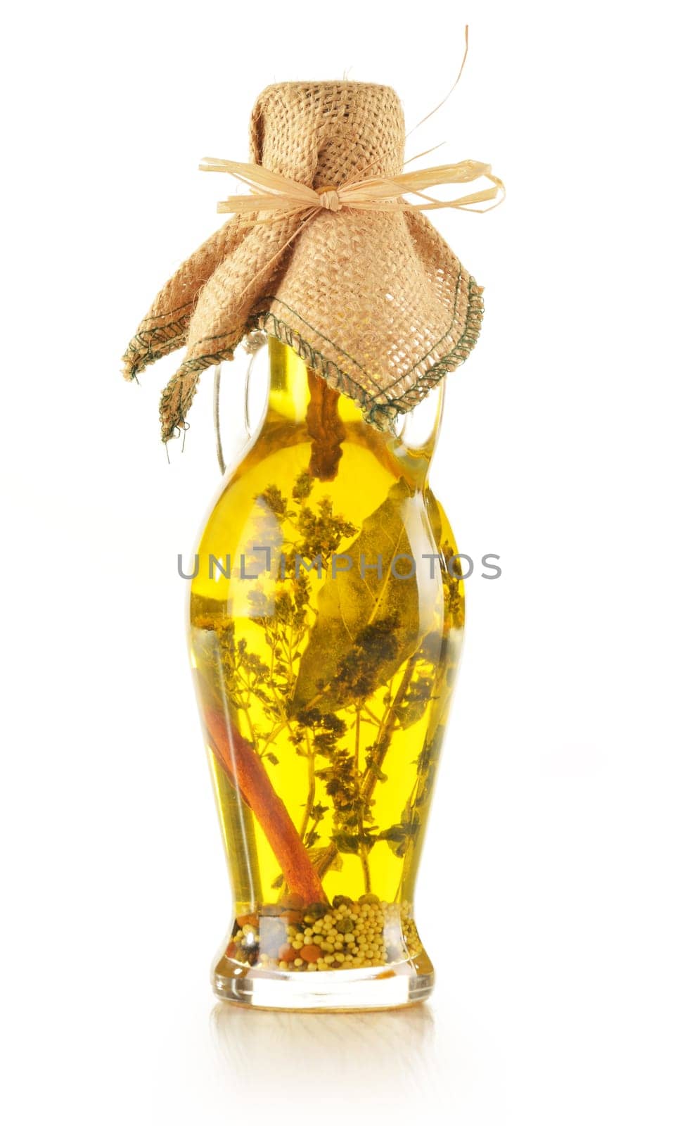 Bottle of traditionaly made extra virgin olive oil with aromatic herbs isolated on white