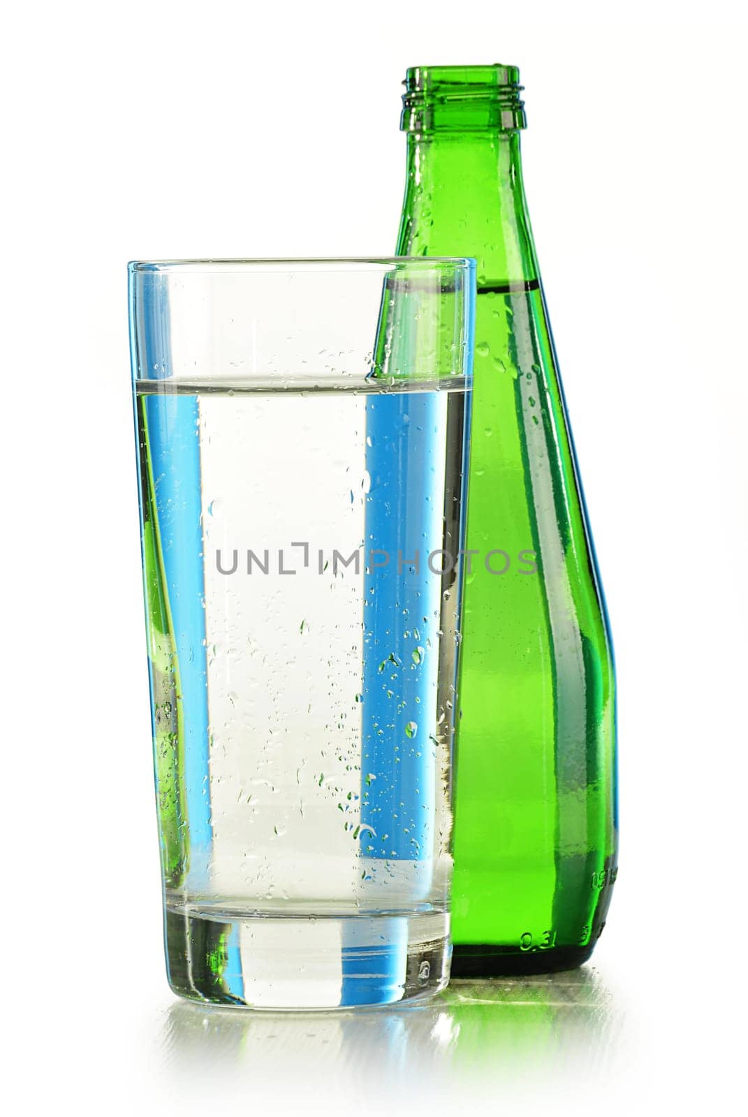 Glass bottle of mineral water isolated on white