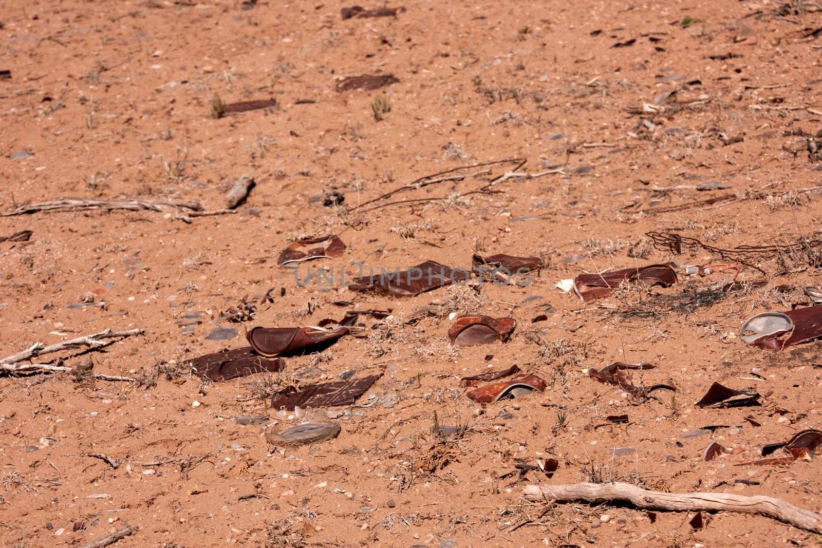 Rusty cans in the desert floor