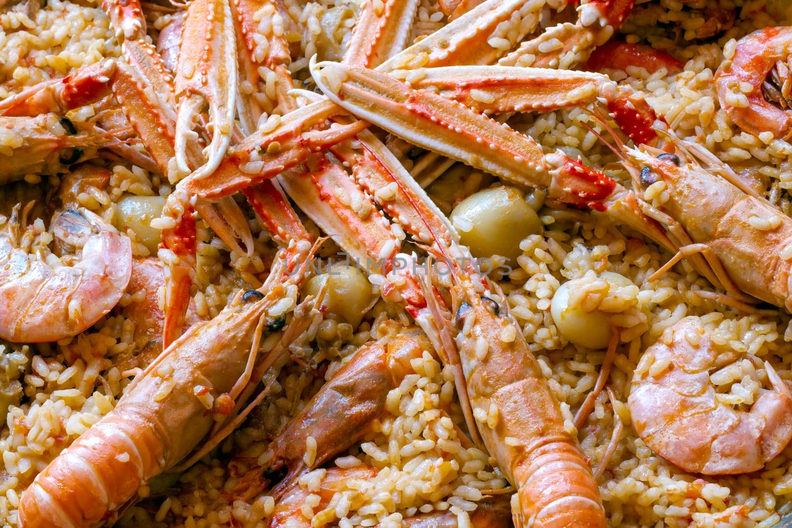traditional spanish paella with prawn on big pan