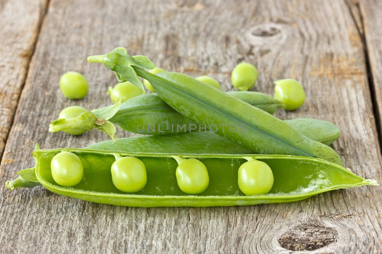 green organic peas on the  wooden background