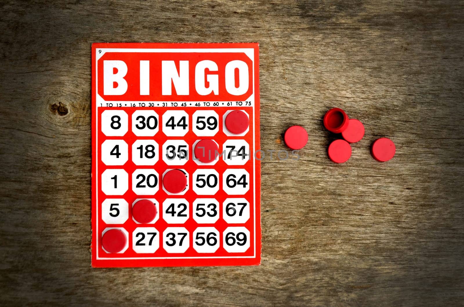 Red bingo card with winning chips