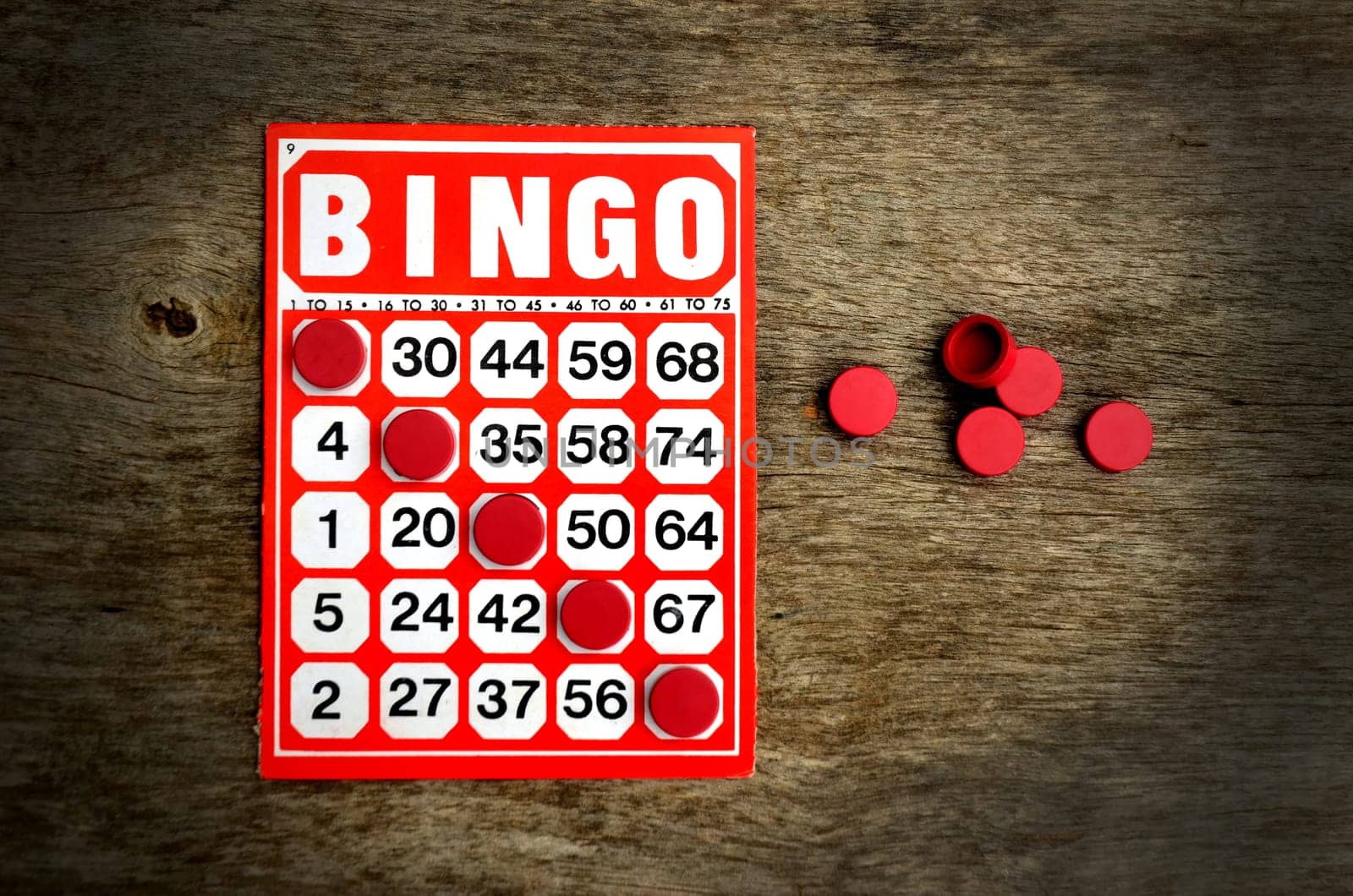 Red bingo card with winning chips