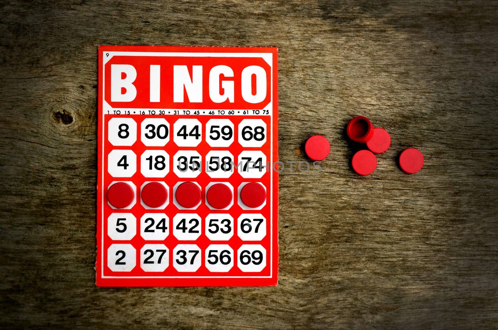 Red bingo card with winning chips