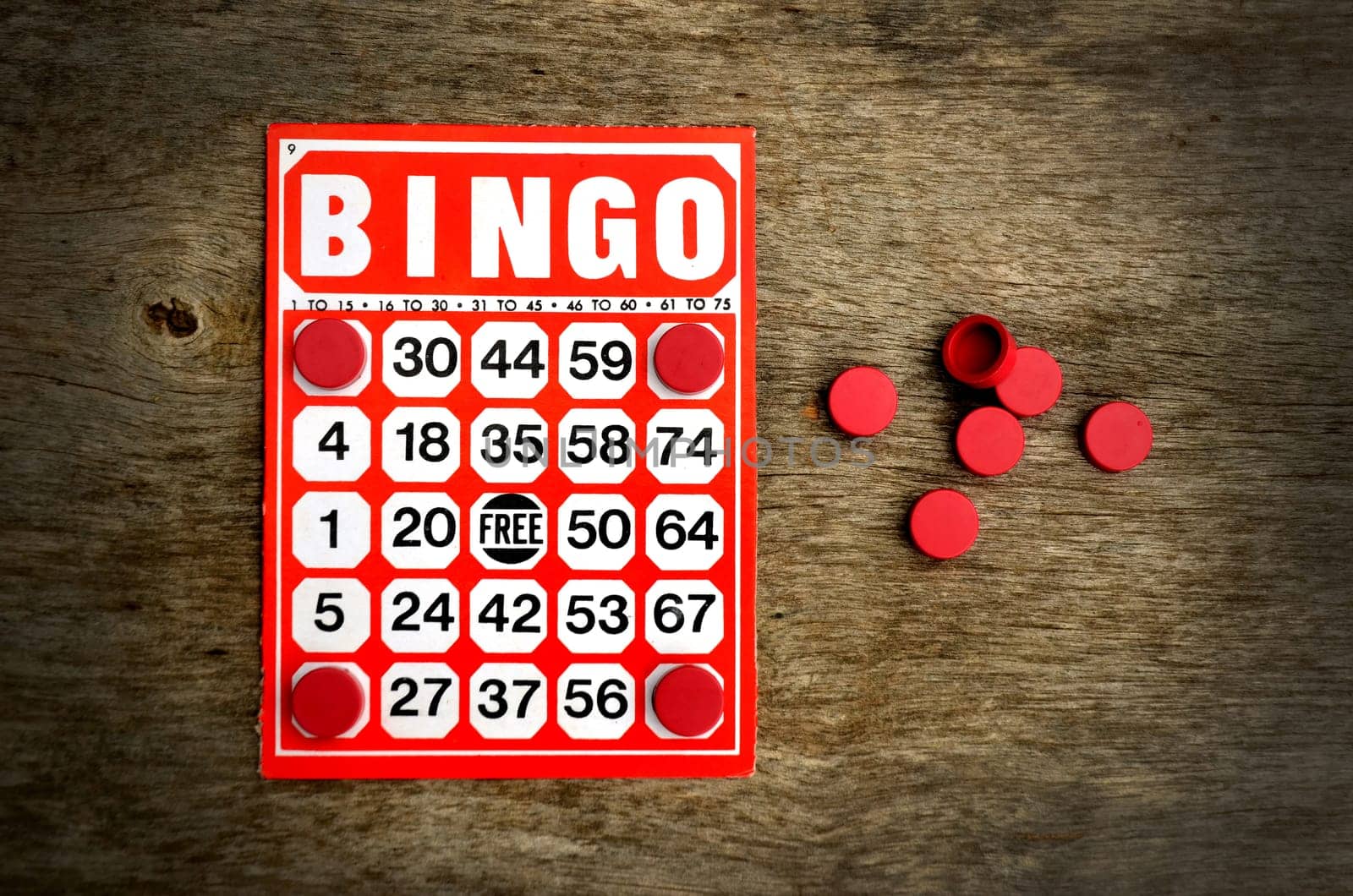 Red bingo card with winning chips