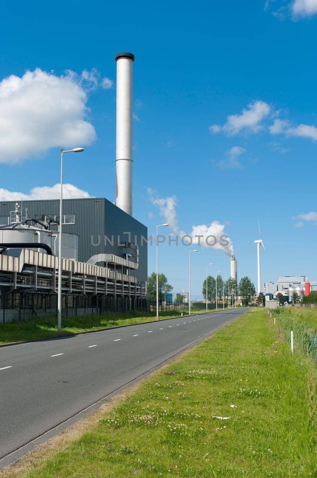 factory with large chimney in amsterdam harbor area