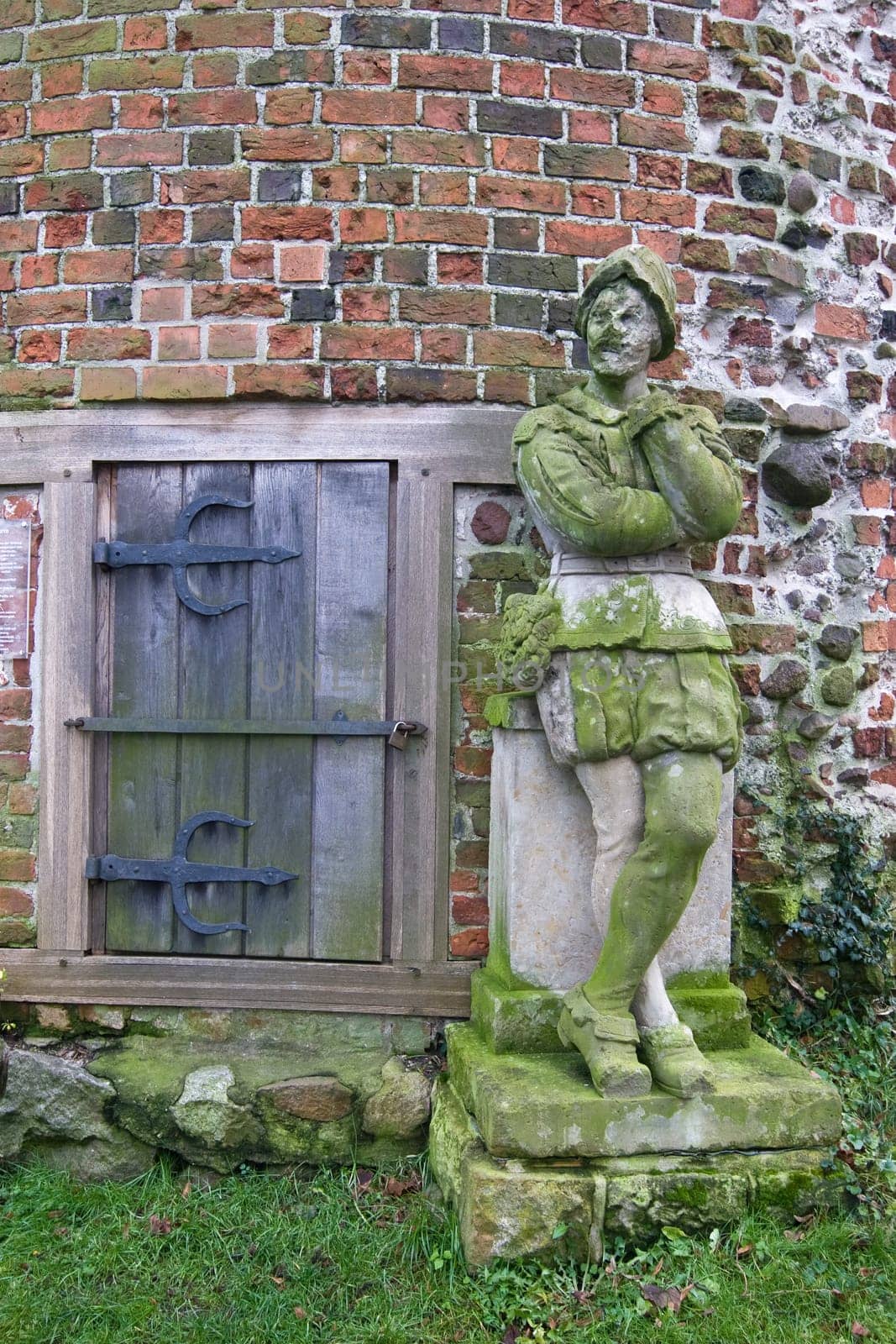 Stone city guard in front of a tower