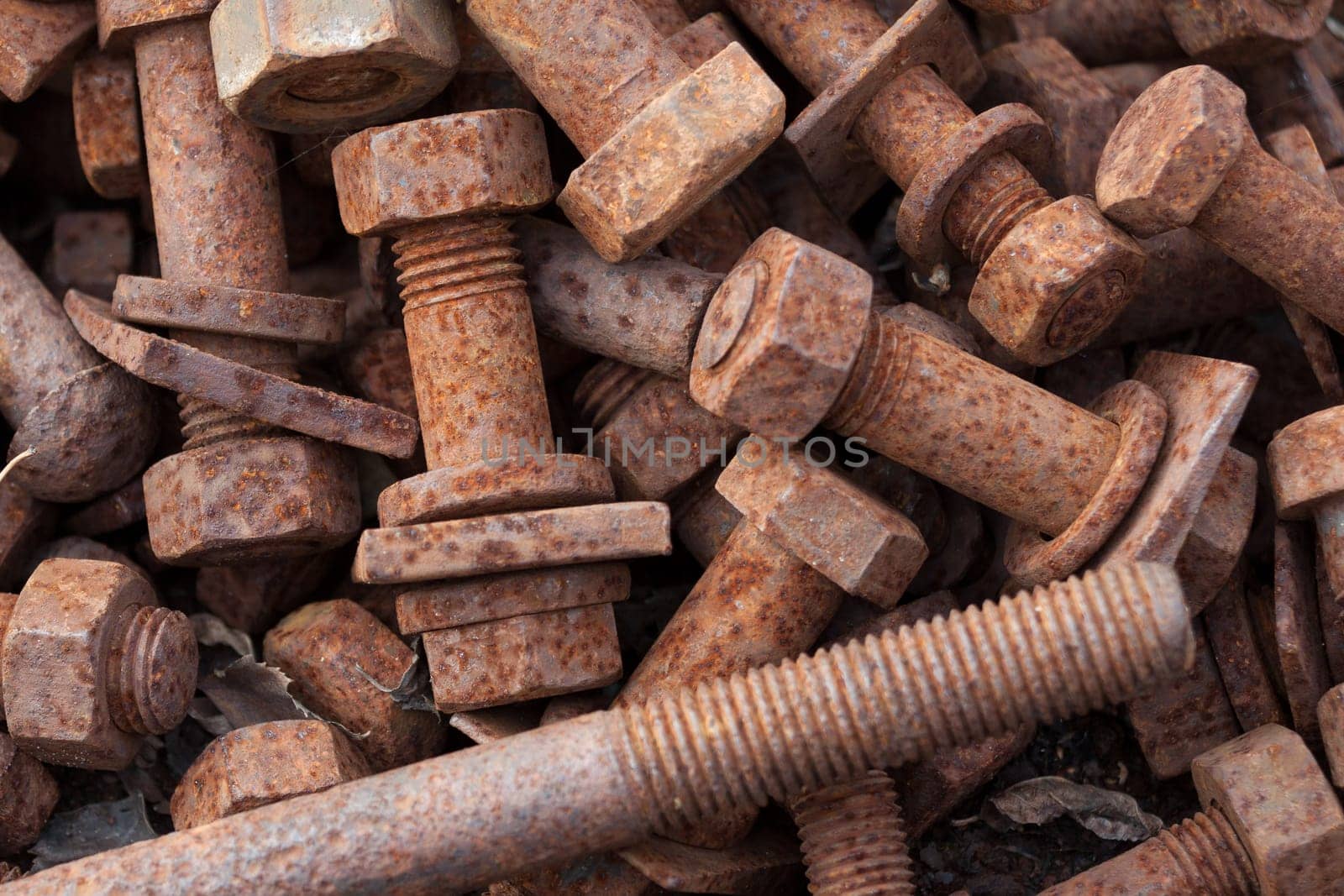Rusty bolts with nuts in a box