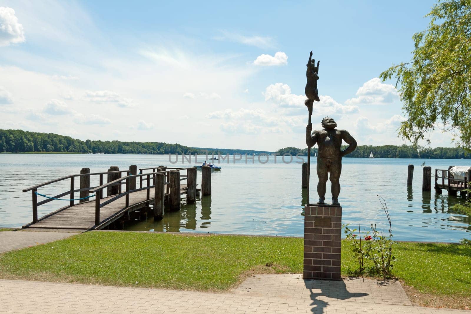 A statue of Neptune stands on the shore of the Scharmützelsee