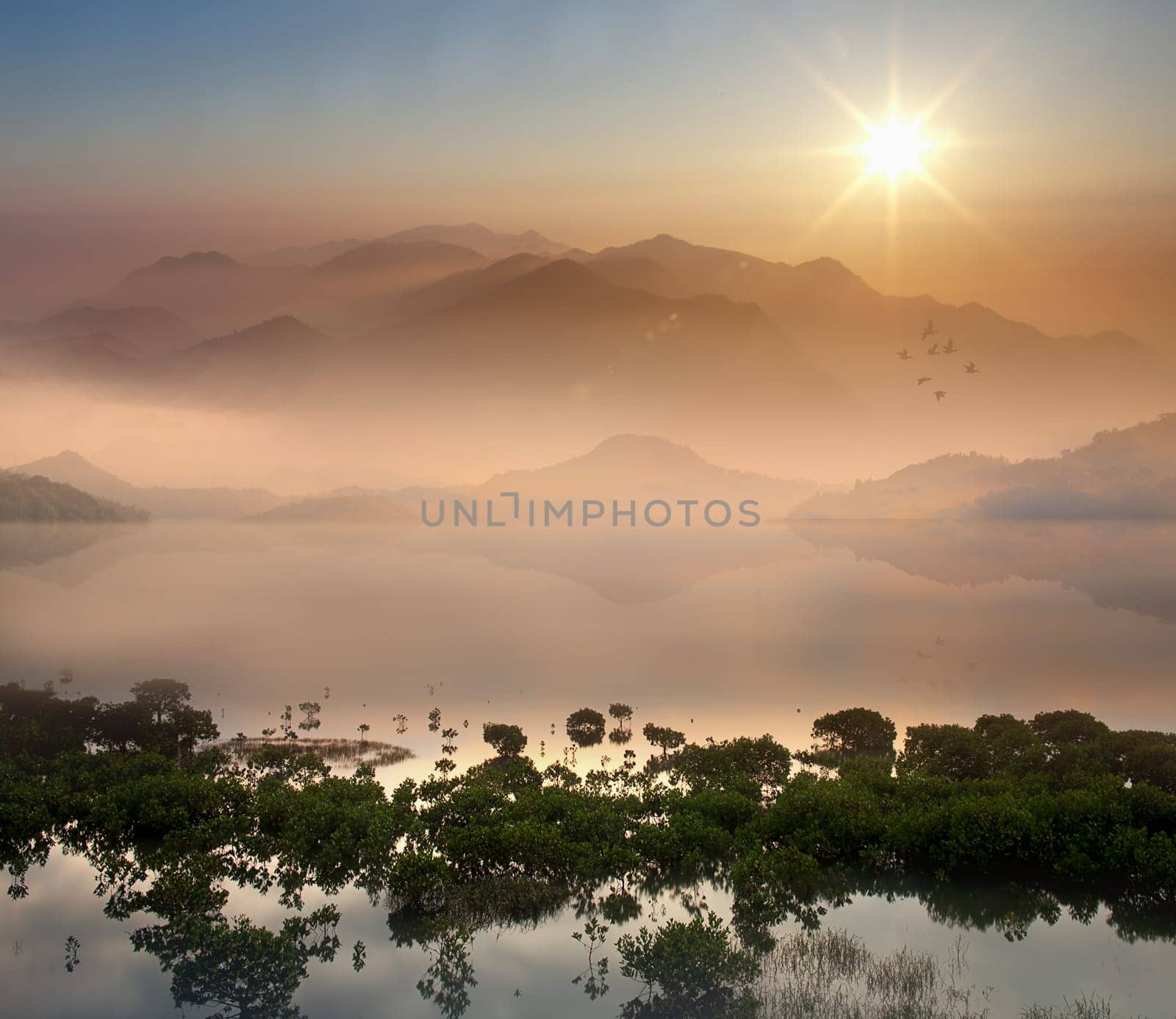 morning lake landscape with sunrise over mountains