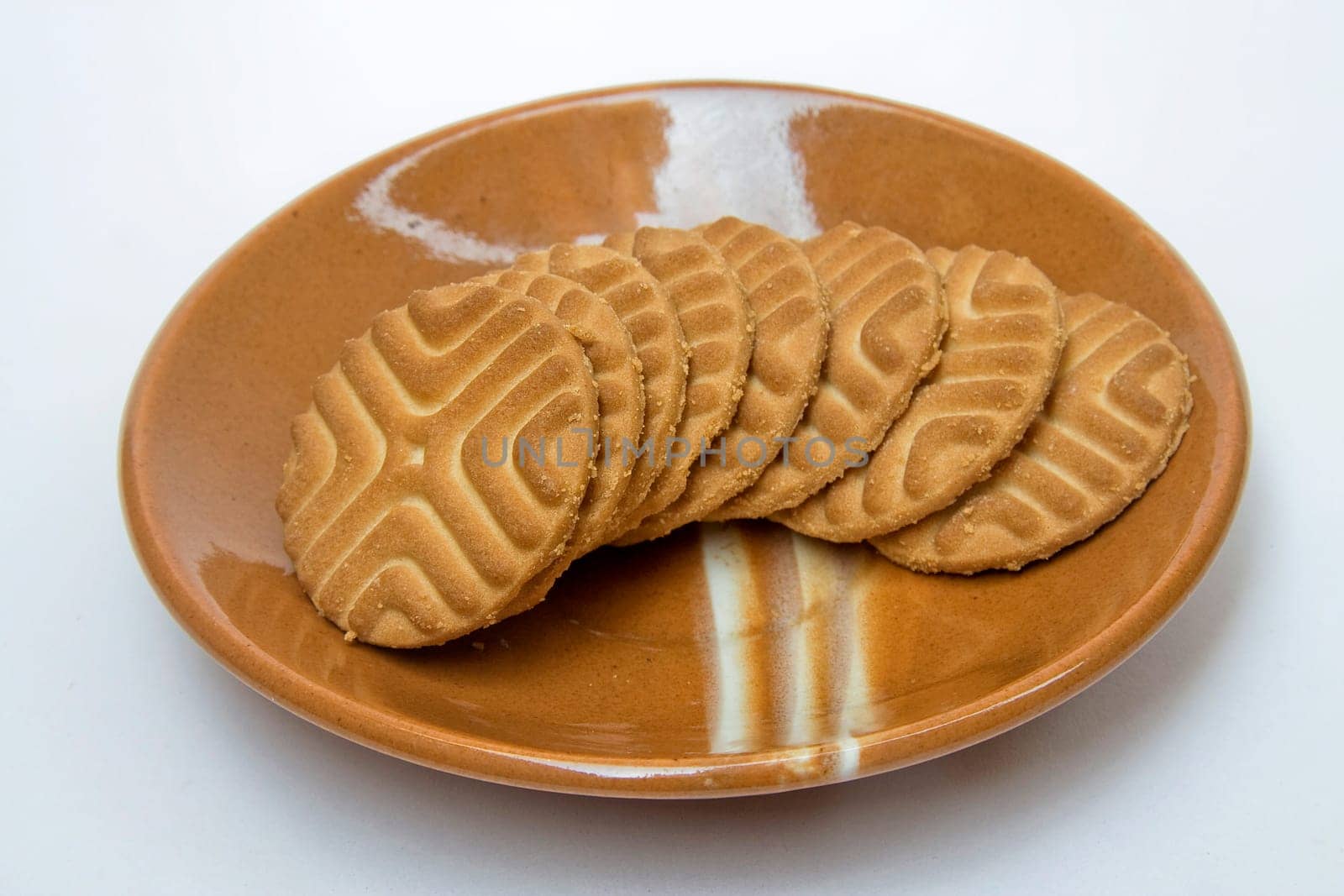 Saucer containing tempting, tasty and crisp biscuits