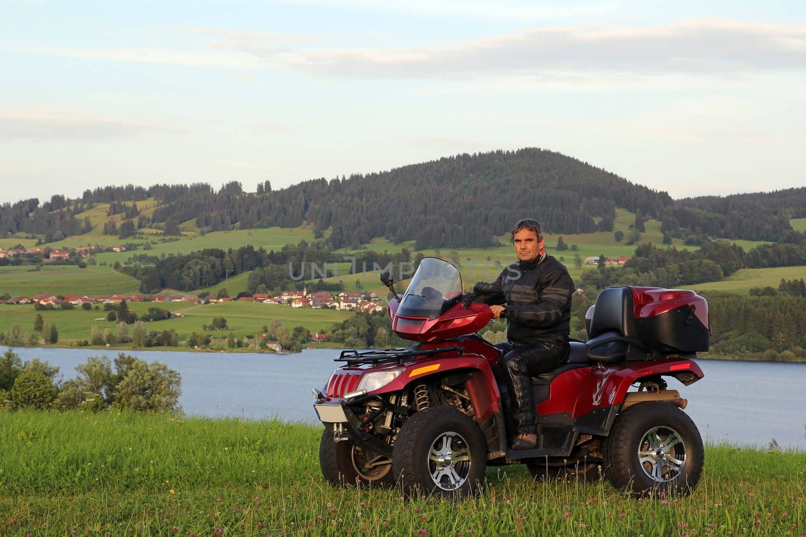 In the summer evening with the ATV at the lake