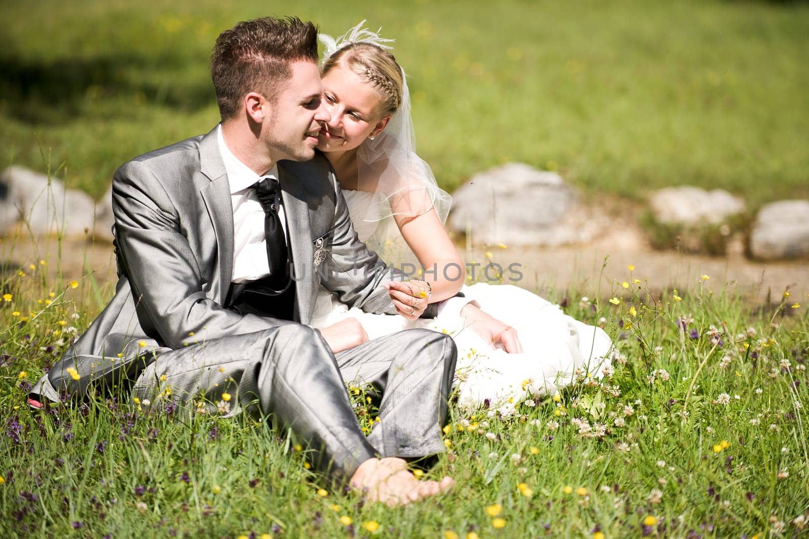Bride and groom with wedding dress and suit in nature