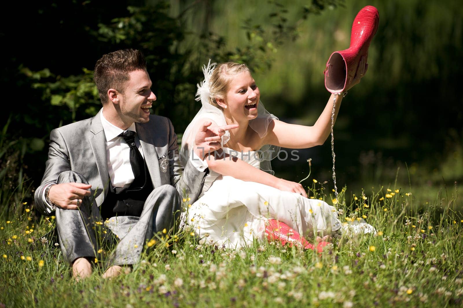 Bride and groom with wedding dress and suit in nature