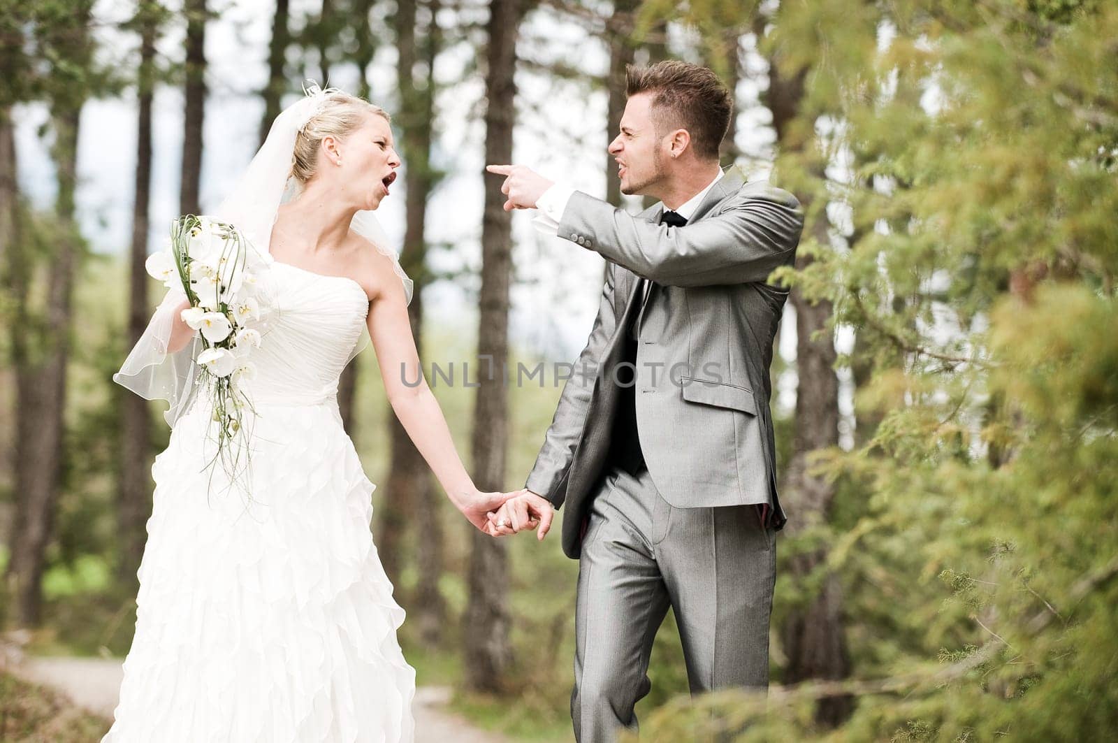 Bride and groom in the forest arguing violently
