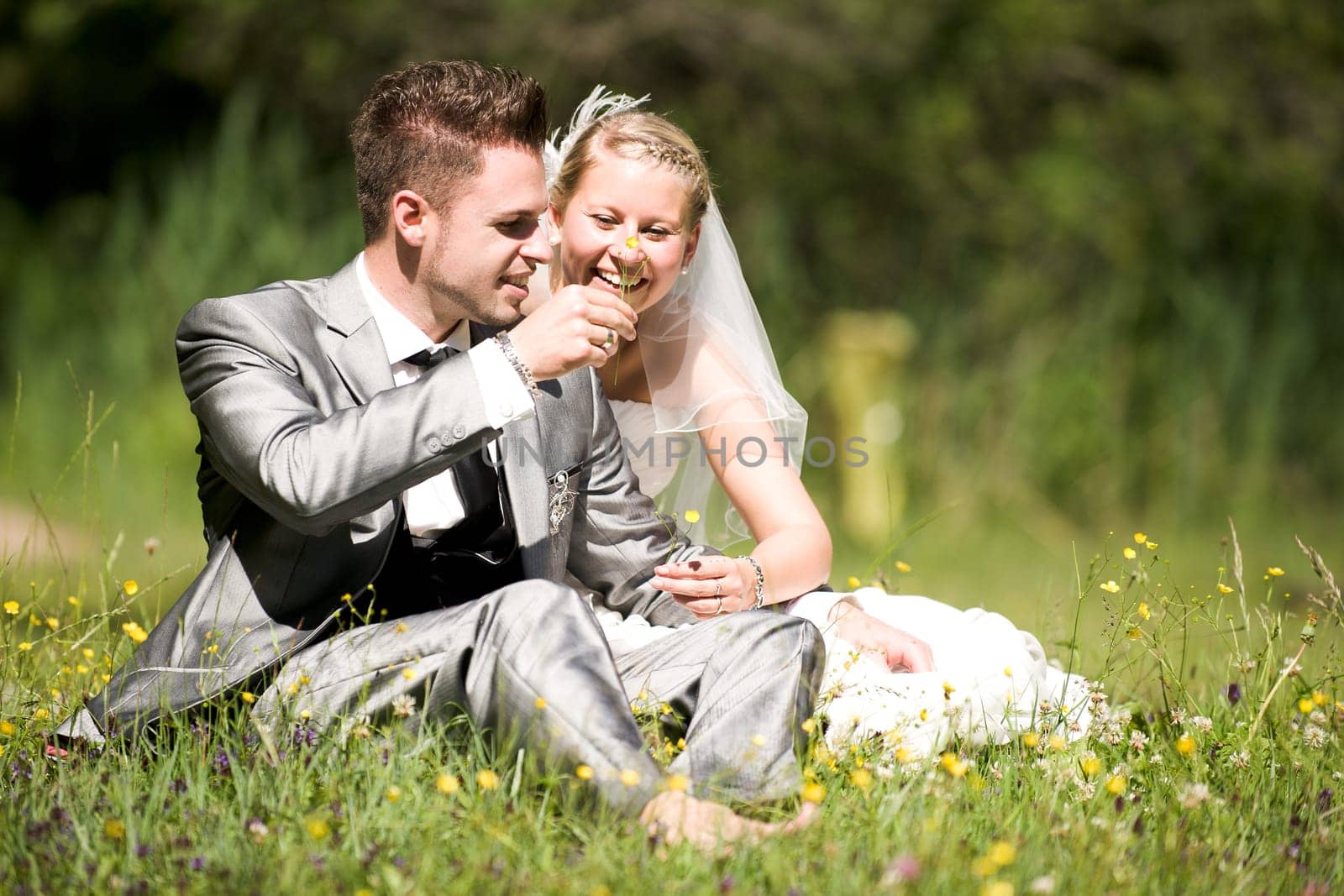 Bride and groom with wedding dress and suit in nature