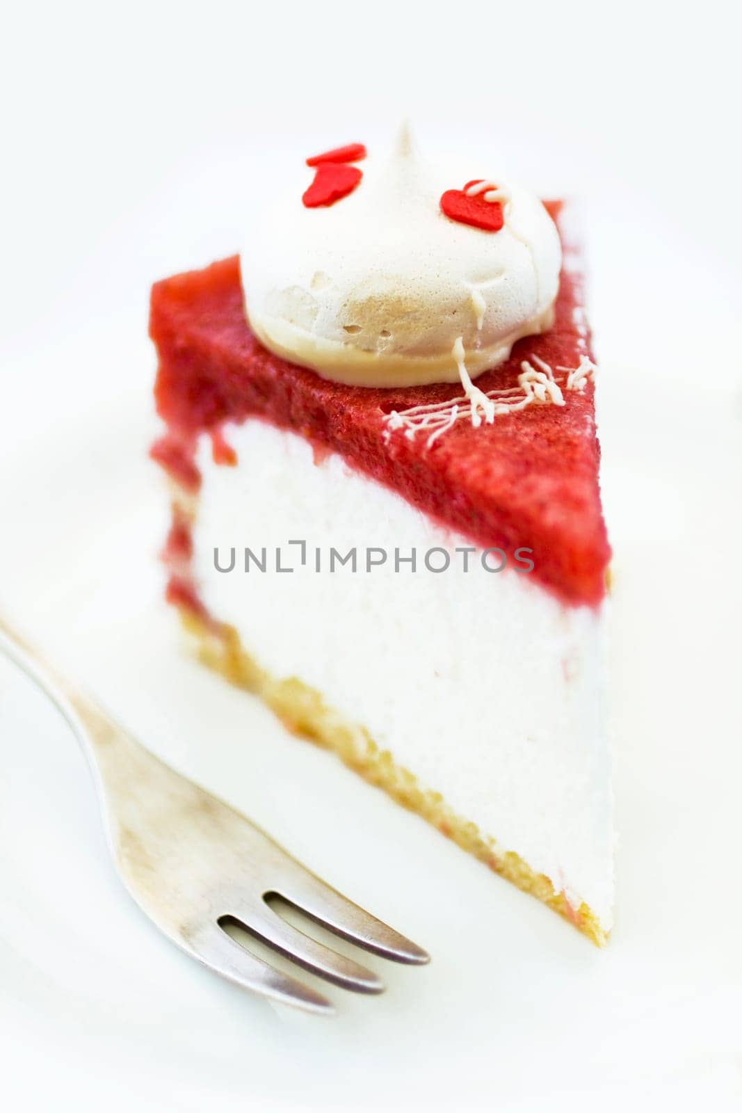 Piece of cake with hearts on plate