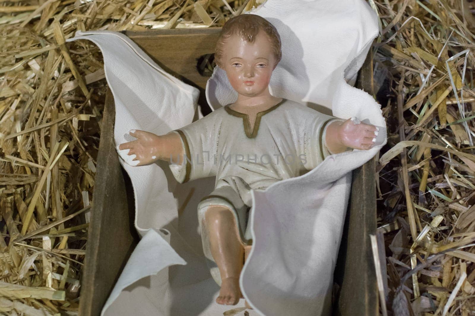 Baby Jesus laying in a cradle Christmas Creche