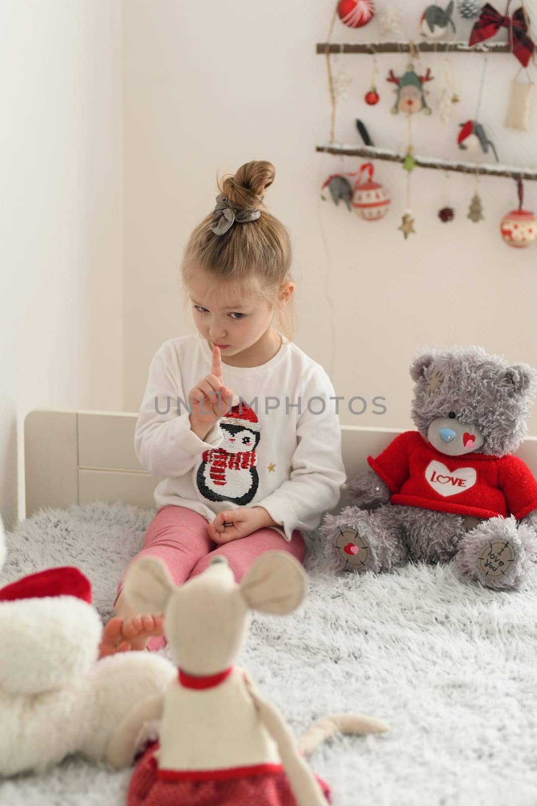 A girl playing in a room with the plush toys