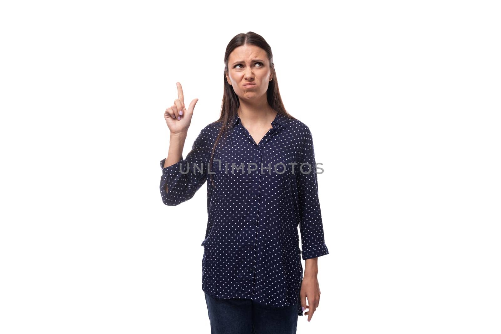 young confident smart brunette woman dressed in a blue blouse with a pattern of peas on a white clean background by TRMK