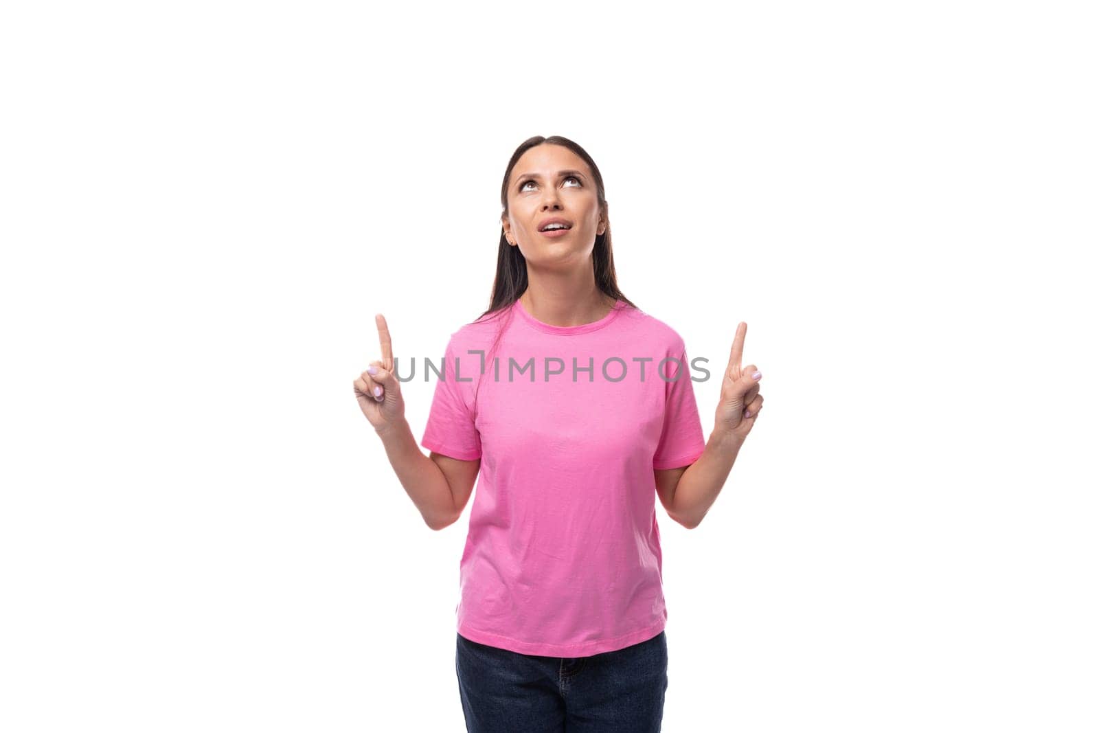 young brunette woman in pink basic t-shirt showing thumbs up isolated on white background with copy space by TRMK