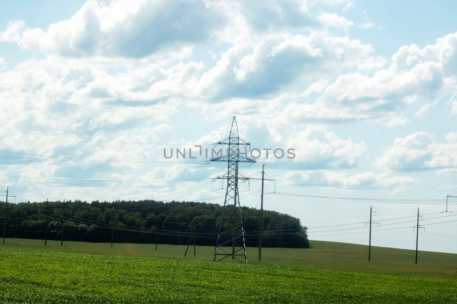 Pole with electric wires on sky background with clouds