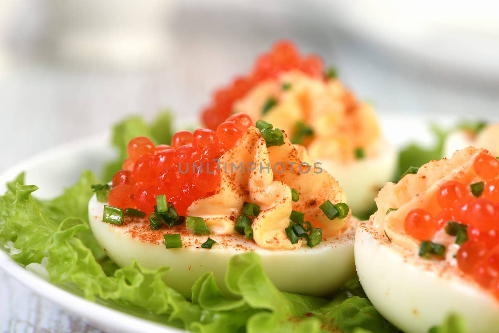 Stuffed eggs with salmon caviar are a popular appetizer for any occasion. Elegantly decorated and expertly seasoned, they will always be a beautiful appetizer at a party.