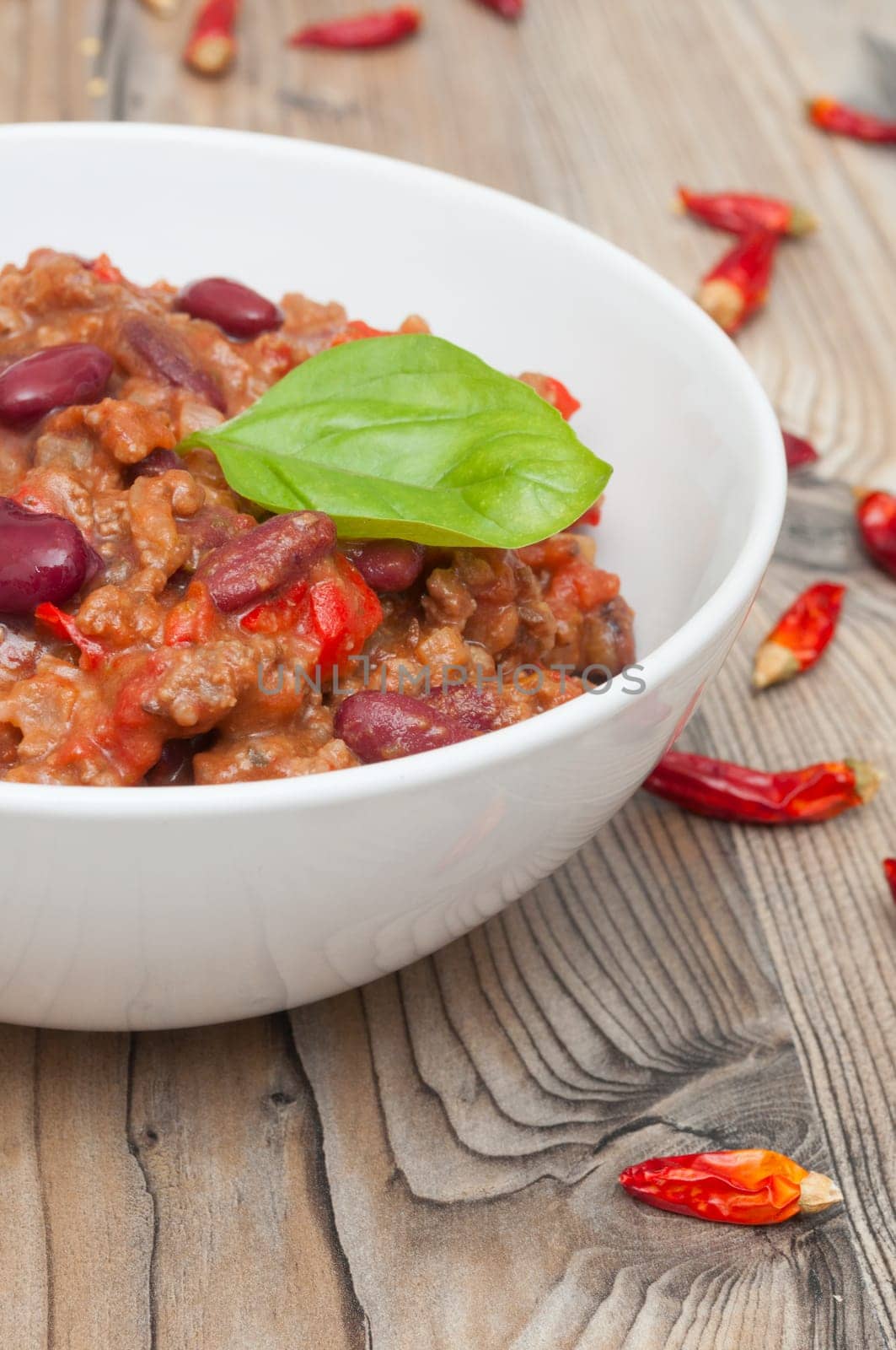 Chilli Con Carne in White Bowl and Red Chili Peppers